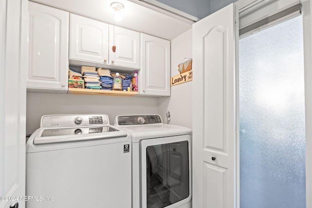 clothes washing area featuring washer and dryer and cabinets