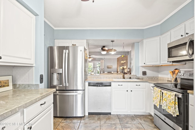 kitchen featuring appliances with stainless steel finishes, tasteful backsplash, sink, white cabinets, and ceiling fan