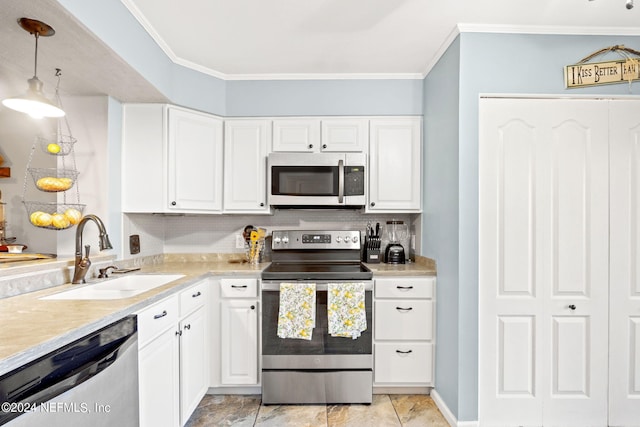 kitchen with sink, stainless steel appliances, crown molding, and light tile patterned flooring