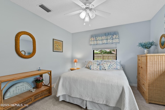 bedroom featuring light carpet and ceiling fan