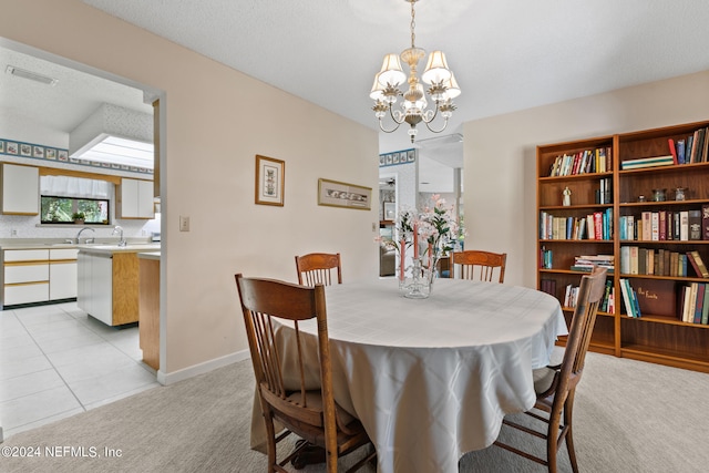 tiled dining space featuring an inviting chandelier and sink