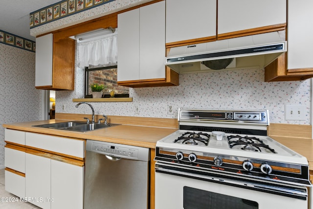 kitchen with white cabinets, stainless steel dishwasher, gas range gas stove, and sink