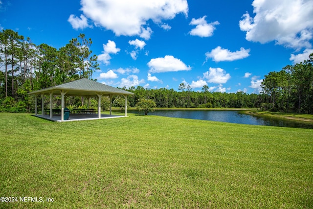 view of community featuring a water view, a lawn, and a gazebo