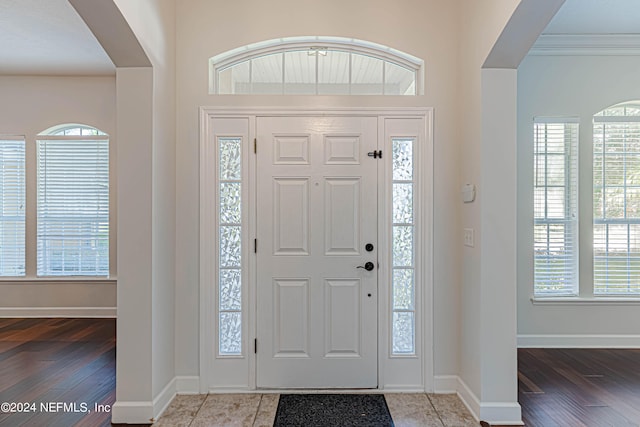 foyer featuring ornamental molding and hardwood / wood-style floors