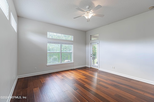 unfurnished room featuring a textured ceiling, ceiling fan, and dark hardwood / wood-style floors