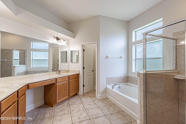 bathroom with vanity, a healthy amount of sunlight, and plus walk in shower