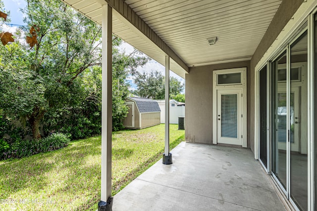 view of patio / terrace with a shed