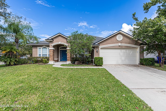 single story home featuring a garage and a front yard