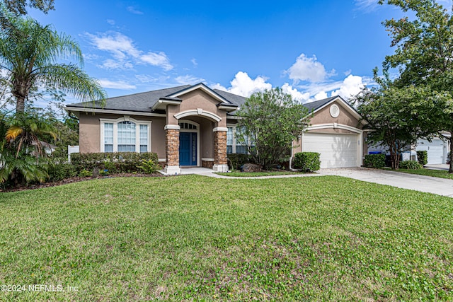 view of front of property with a garage and a front lawn