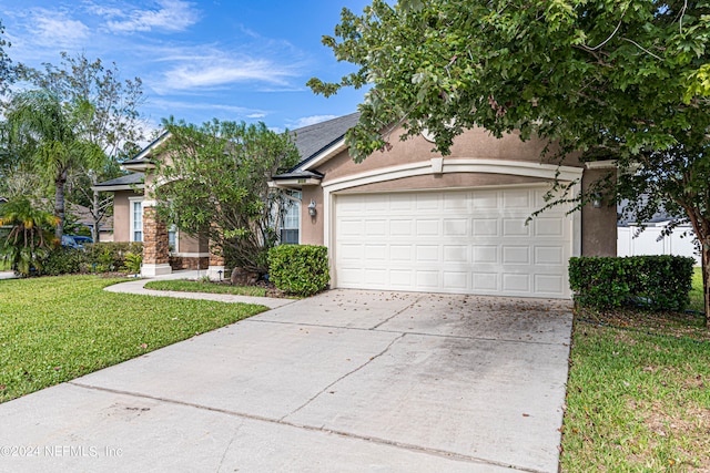 view of front of home with a garage and a front yard