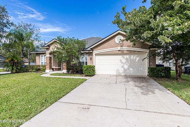 ranch-style house featuring a garage and a front lawn