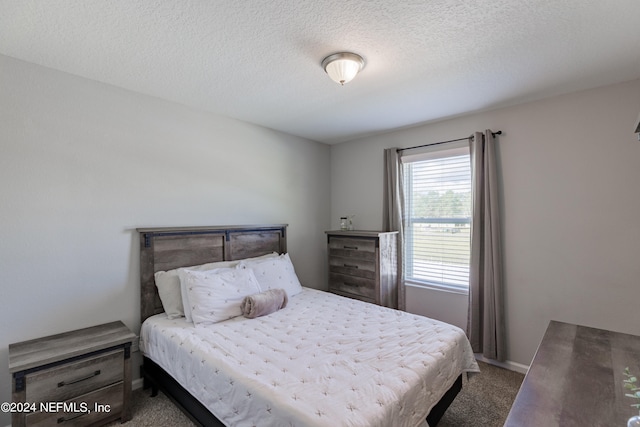 carpeted bedroom with a textured ceiling