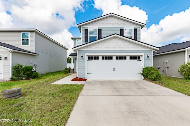 view of front of house with a garage and a front lawn