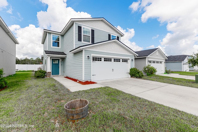 view of front of home featuring a front yard and a garage