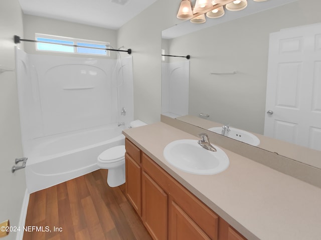 full bathroom with  shower combination, hardwood / wood-style flooring, toilet, and vanity