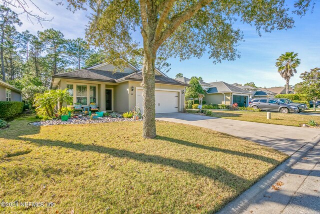 ranch-style home with a garage and a front yard