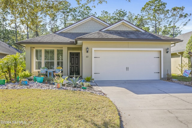 view of front of property with a front yard and a garage