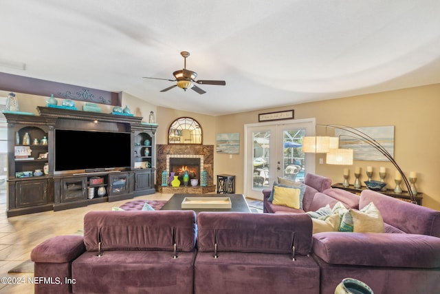 tiled living room with ceiling fan, french doors, and a high end fireplace