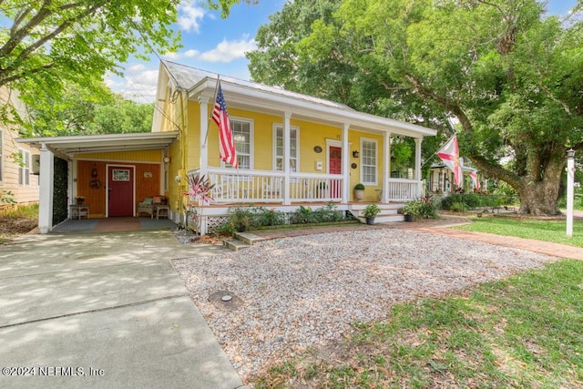 view of front of house with a carport, covered porch, and driveway