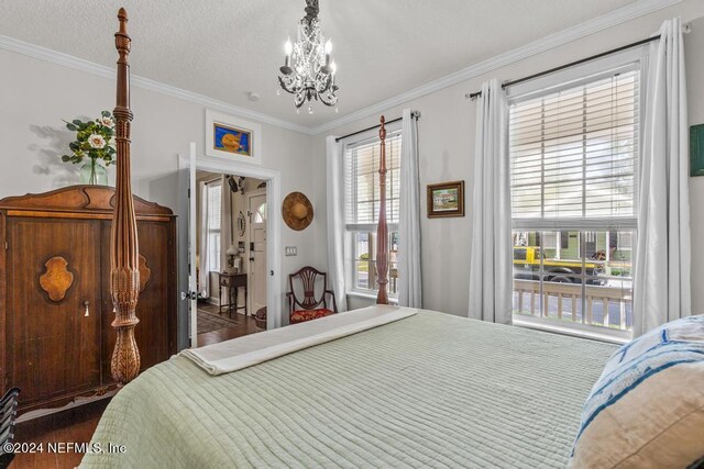 bedroom with ornamental molding, dark hardwood / wood-style floors, a chandelier, and a textured ceiling