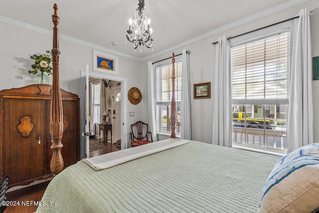 bedroom with a textured ceiling, a notable chandelier, and ornamental molding