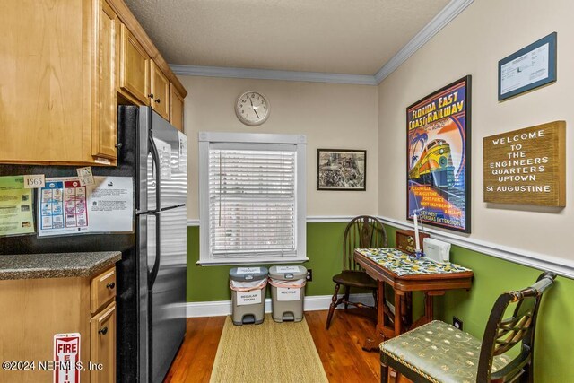 kitchen featuring dark wood-type flooring and ornamental molding