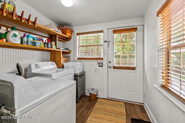 laundry room with washing machine and clothes dryer, laundry area, dark wood finished floors, and baseboards