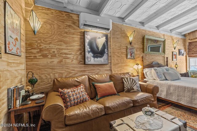 bedroom featuring a wall unit AC, wooden walls, and beam ceiling