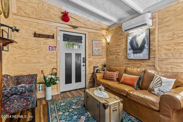 living room featuring a wall mounted air conditioner, wood finished floors, and wood walls