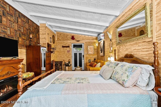 bedroom with lofted ceiling, an AC wall unit, and wooden walls