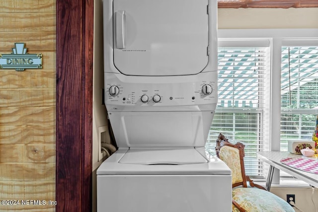 clothes washing area with laundry area and stacked washer / dryer