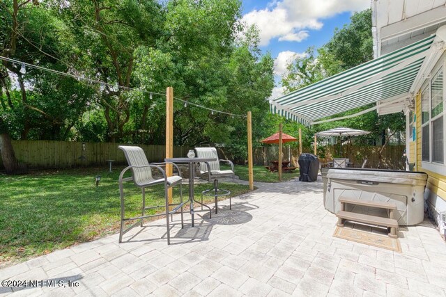 view of patio / terrace with a hot tub