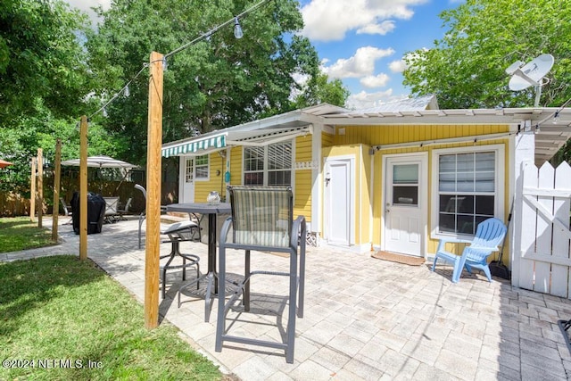 view of patio featuring outdoor dining area and fence