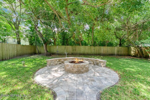 view of yard featuring a fire pit and a patio area