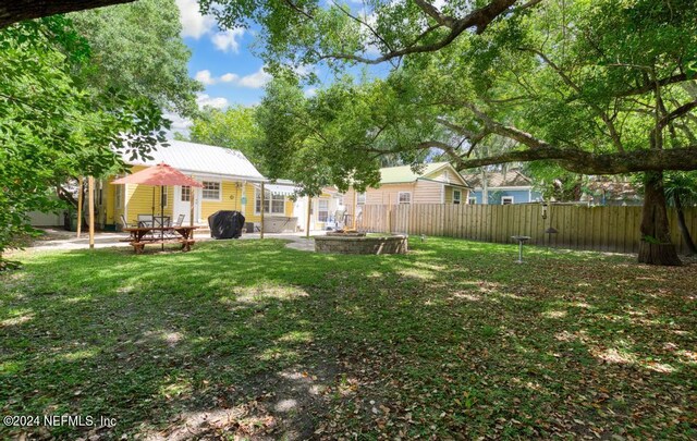 view of yard with an outdoor fire pit