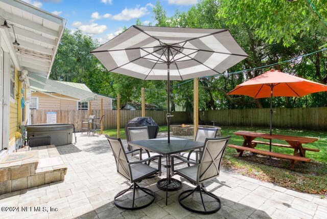 view of patio / terrace with a hot tub