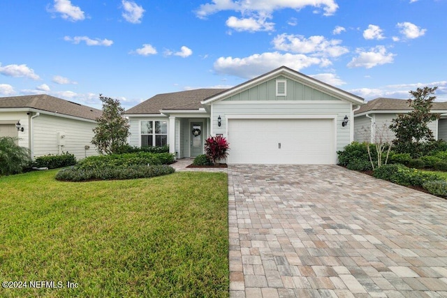 ranch-style house featuring a front yard and a garage