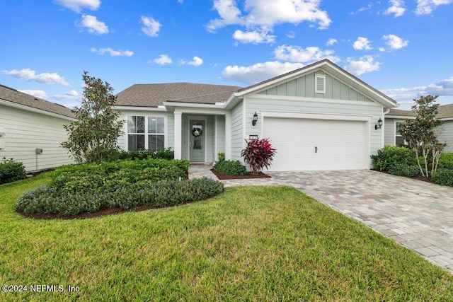 ranch-style home with a garage and a front yard