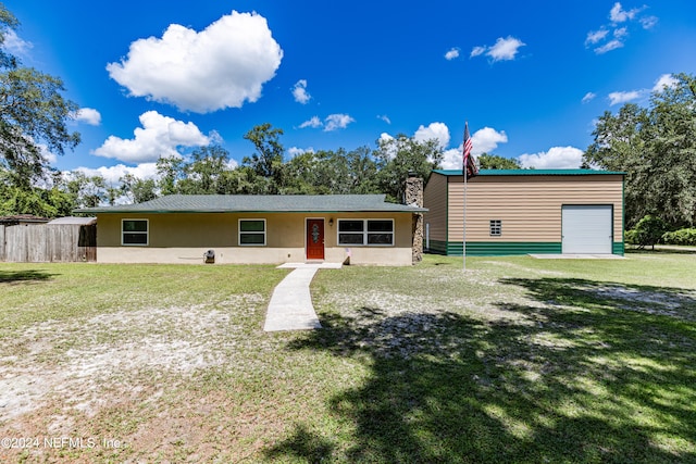 view of front of house with a garage and a front yard