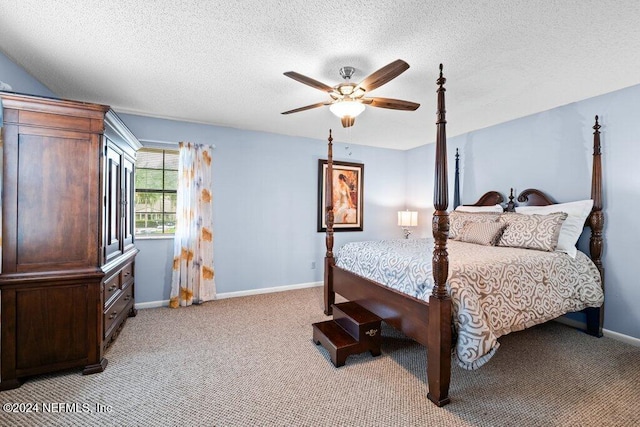 bedroom with ceiling fan, light colored carpet, and a textured ceiling