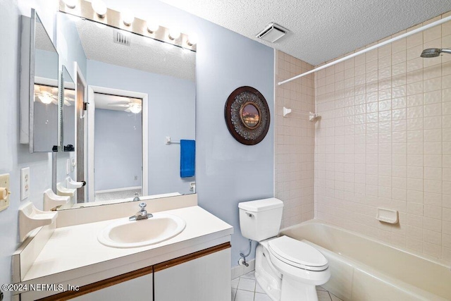 full bathroom with toilet, a textured ceiling, vanity, tiled shower / bath combo, and tile patterned flooring