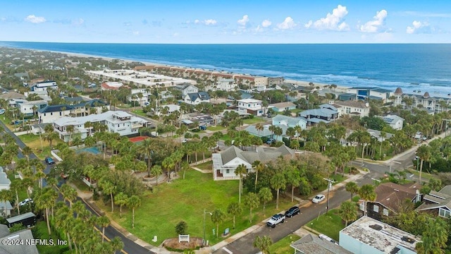 birds eye view of property featuring a water view and a beach view