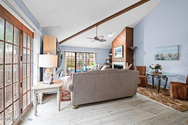 living room with ceiling fan, high vaulted ceiling, and a textured ceiling