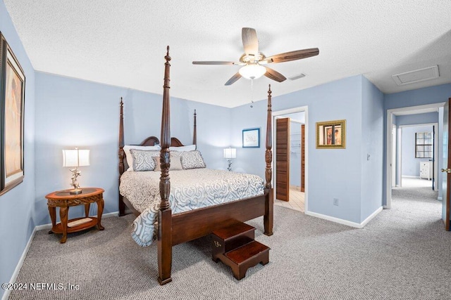 bedroom with ceiling fan, a textured ceiling, and carpet flooring