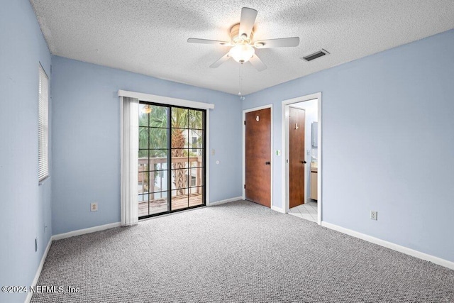 unfurnished room with ceiling fan, light carpet, and a textured ceiling