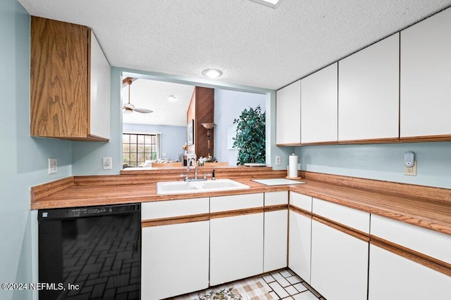 kitchen with black dishwasher, sink, a textured ceiling, and white cabinets