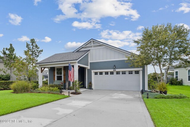 view of front facade featuring a garage, a porch, and a front lawn