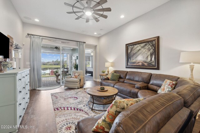 living room with hardwood / wood-style floors and ceiling fan