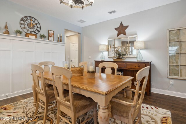 dining space featuring dark wood-type flooring