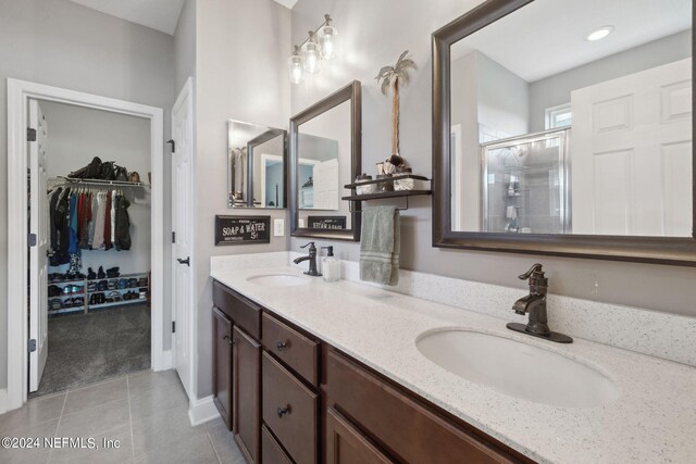 bathroom with vanity, walk in shower, and tile patterned floors